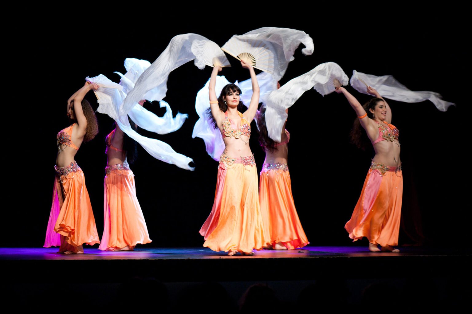 Bellydancers with flutters on performance stage